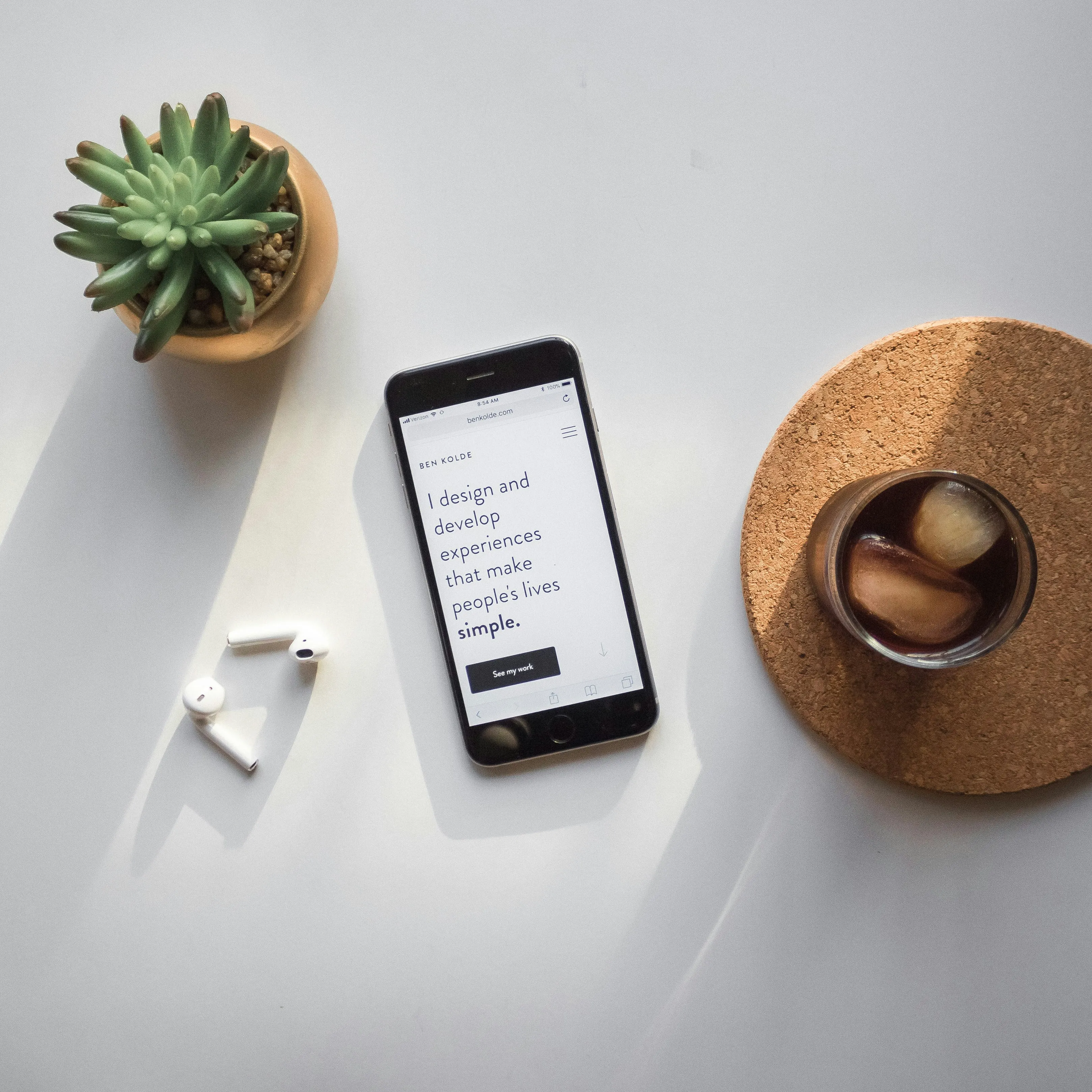 iPhone with mockup of a website displayed